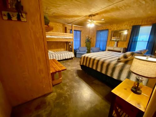 a bedroom with a bed and a table with a lamp at HILLSIDE in Concan