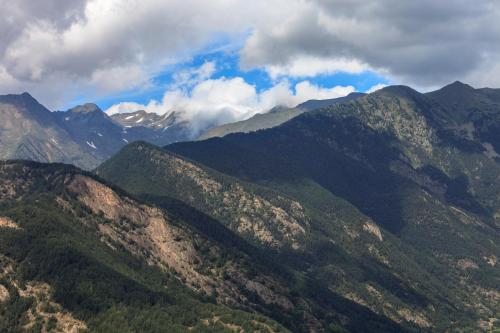 a view of a mountain range with clouds in the sky at Insitu Eurotel Andorra in Andorra la Vella