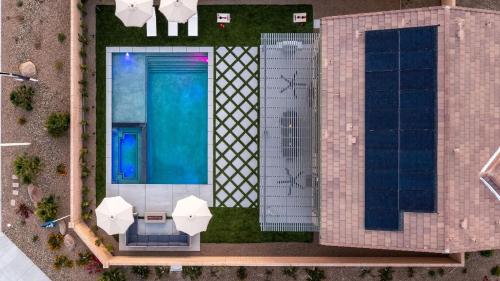 Desert Eden by AvantStay 6BR w Ensuite Backyard Oasis w Pool Hot Tub في كوتشيلا: اطلالة علوية على مبنى به مسبح