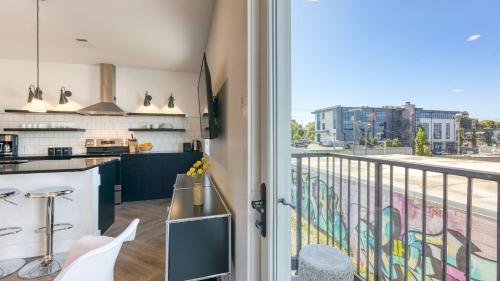 a kitchen with a balcony with a view of a street at The Carter by AvantStay in Nashville