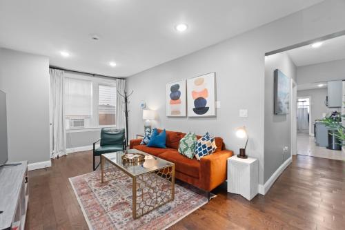a living room with a couch and a table at Urban Charm | Near EWR Airport Easy Access to NYC in Newark