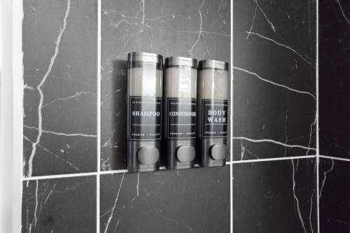 a row of four batteries on a tile wall at Urban Charm | Near EWR Airport Easy Access to NYC in Newark