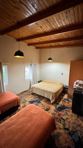 a bedroom with two beds in a room at Alojamiento Napoleon in Puerto Iguazú