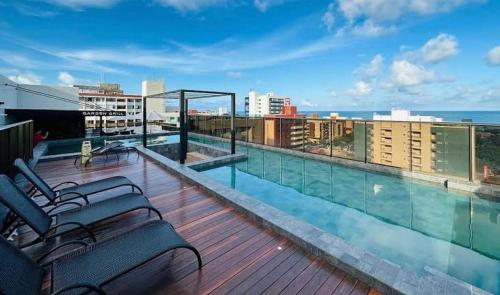 a balcony with a swimming pool on top of a building at Comfort and elegance in the heart of Cabo Branco in João Pessoa