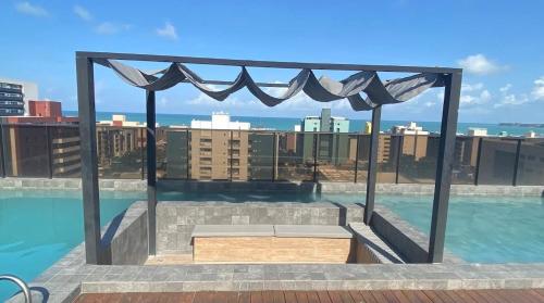 a view of a swimming pool on top of a building at Comfort and elegance in the heart of Cabo Branco in João Pessoa