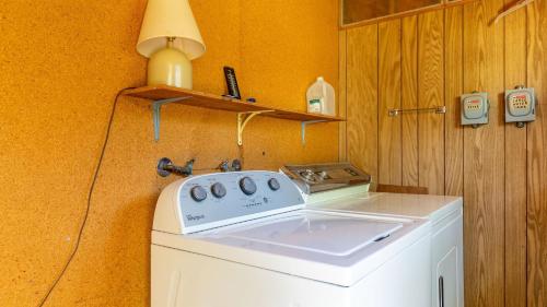 a washing machine with a lamp on top of it at Mutiny Bay Waterfront Cabin by AvantStay Views in Freeland