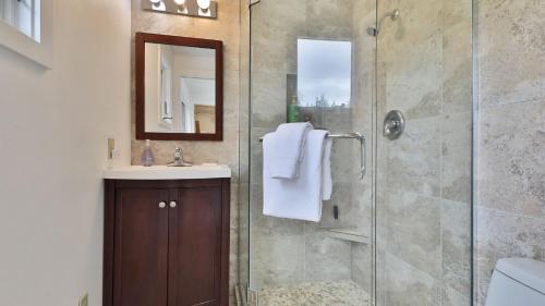 Marine View Bluff by AvantStay Waterfront Views في Greenbank: حمام مع دش ومغسلة ومرآة