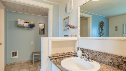 a bathroom with a sink and a mirror at West Beach Wonderland by AvantStay Waterfront in Oak Harbor