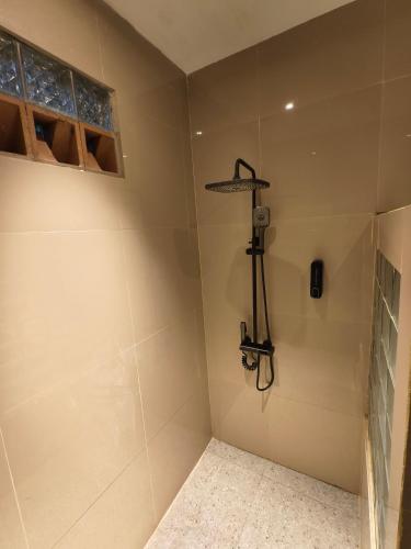 a bathroom with a shower with a camera in it at Sunriver Hotel in Bandung