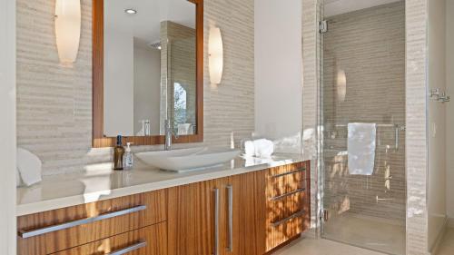 a bathroom with a sink and a mirror at Wine Country Estate w Pool Hot Tub The Residence at Truss Wines by AvantStay in Paso Robles