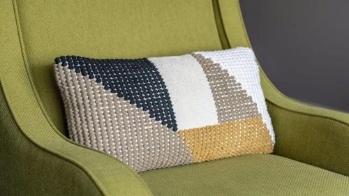 Hay una almohada sobre una silla verde. en CozySuites Remi sauna, pool, gym, en Dallas