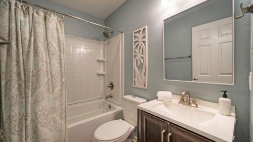 a bathroom with a sink and a toilet and a tub at Stylish 2BR Coastal Getaway w Pool Prime Location Lazy Fun in Port Aransas