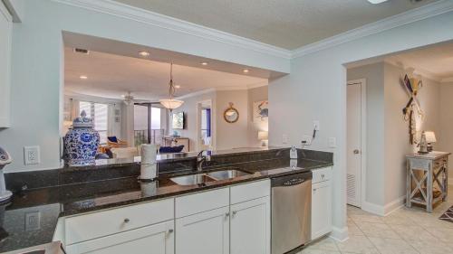 a kitchen with a sink and a large mirror at 308 Summerhouse by AvantStay Oceanview Condo w Community Pool Access in Isle of Palms