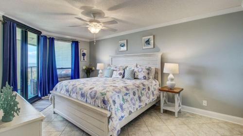 a bedroom with a bed and a ceiling fan at 308 Summerhouse by AvantStay Oceanview Condo w Community Pool Access in Isle of Palms