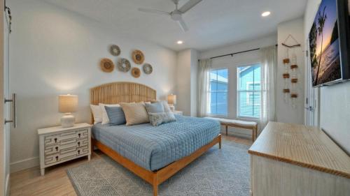 a bedroom with a bed and a dresser and a window at Free Heated Pool Golf Cart Zone Sea La Vie by AvantStay in Port Aransas