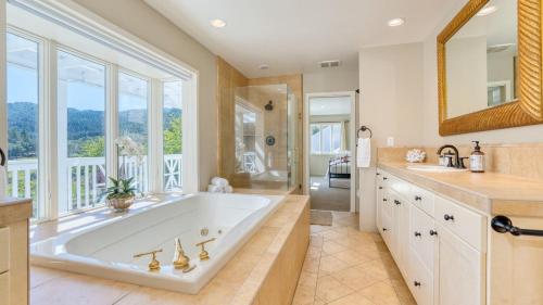 a large bathroom with a large tub and a window at Sonoma Sunshine by AvantStay Countryside Views in Glen Ellen