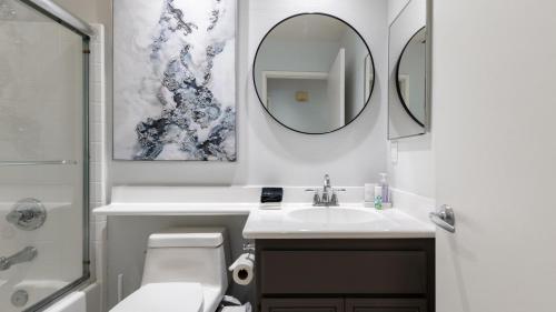 a white bathroom with a sink and a mirror at Pacifica Sur by AvantStay Pool Hot Tub Gazebo in Indio