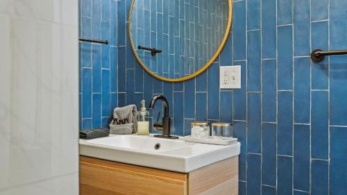 a bathroom with a sink and a mirror at Lake Daze by AvantStay Lakefront w Modern Interior Enclosed Porch Hot Tub in Long Pond