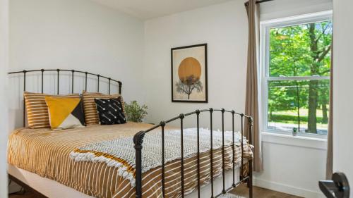 a bedroom with a bed and a window at Lake Daze by AvantStay Lakefront w Modern Interior Enclosed Porch Hot Tub in Long Pond