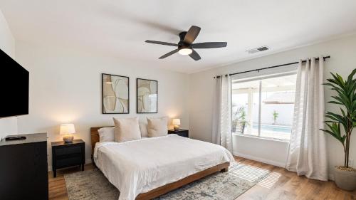 a bedroom with a bed and a ceiling fan at Montego by AvantStay Private Yard w Pool Hot Tub in Indio