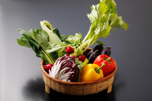 a basket of vegetables sitting on a table at Wakamiro in Hokuto