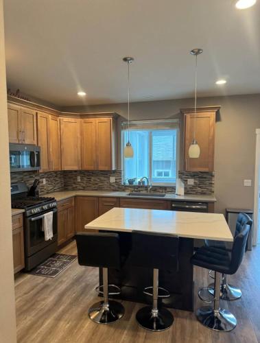 a kitchen with wooden cabinets and a table and chairs at Home in Vancouver in Vancouver