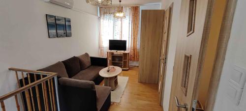 a living room with a couch and a television at unit_type_semidetached_house Siofok 54624 in Balatonszabadi Fürdőtelep