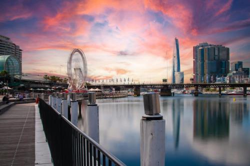 a view of a city with a bridge over the water at ICC & Darling Harbour Stylish 3BR House with Parking in Sydney