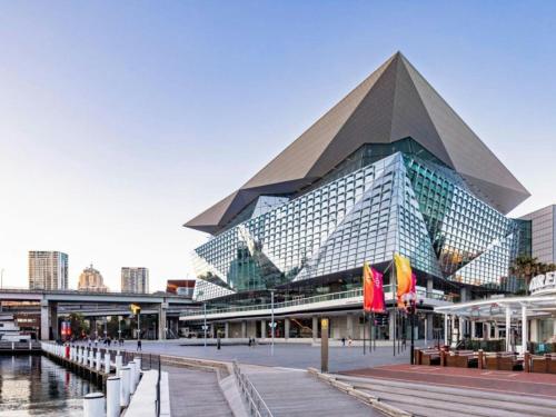 a large building with a pyramid in a city at ICC & Darling Harbour Stylish 3BR House with Parking in Sydney