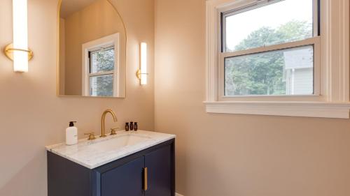 a bathroom with a sink and a window at Game Farm Villa by AvantStay 10BDR Private Pond Spa Pool Family-Friendly in Catskill