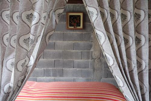 a stairway with a bed with a curtain and stairs at Chrisma Bed and Breakfast in Tomohon