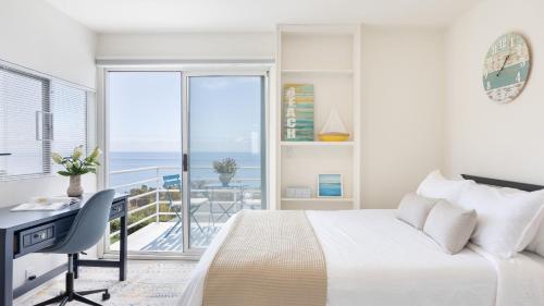a bedroom with a bed and a desk and a balcony at Stardust by AvantStay Views Hot Tub Pool Table in Malibu