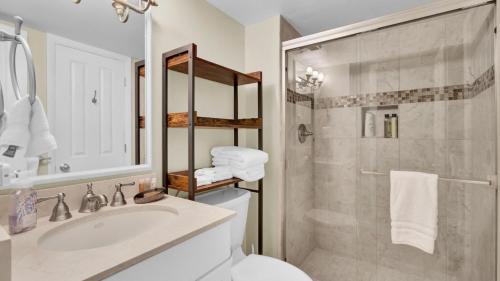 a bathroom with a toilet and a sink and a shower at 123D Shipwatch by AvantStay Beach Access Pool in Isle of Palms
