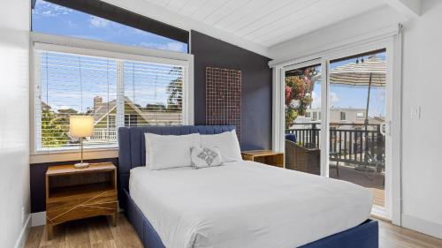 a bedroom with a bed and a large window at Stone Lagoon by AvantStay Steps to the Beach Backyard Oasis in San Clemente