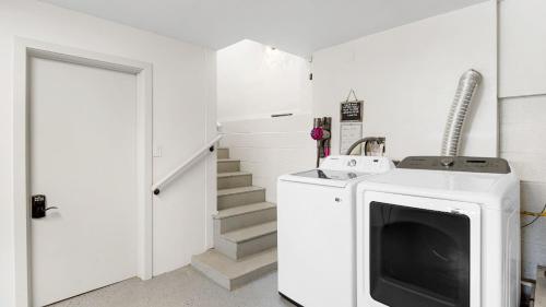a laundry room with a dryer and a washing machine at Stone Lagoon by AvantStay Steps to the Beach Backyard Oasis in San Clemente