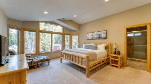a bedroom with a bed and a desk and windows at Washoe Chalet by AvantStay Game Room Hot Tub Putting Green Fire Pit in Tahoma