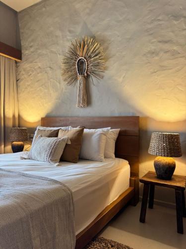 a bedroom with a large bed with a flower on the wall at Villa Vento in Camocim