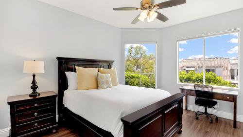 a bedroom with a bed and a desk and a window at Encantamar Escape by AvantStay Prime Location Community Amenities in Dana Point