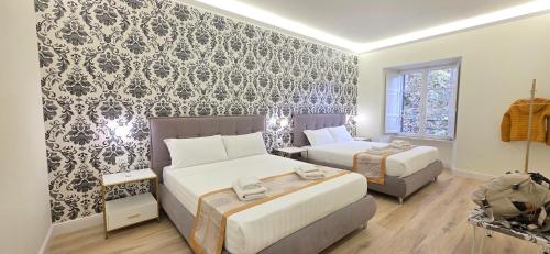 a bedroom with two beds and a wall mural at Rome Aparts in Rome