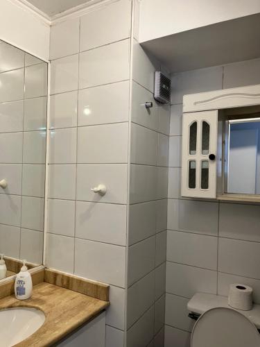 a white bathroom with a sink and a toilet at Departamento Santiago Centro Full Equipado in Santiago