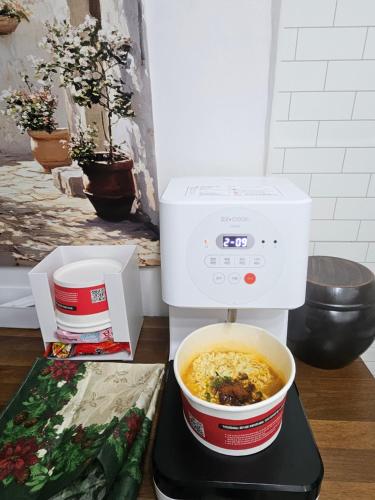 a food processor sitting on a table with a bowl of food at Romantic Winter Package , K-Culture Experience Itaewon 7min,2F Korean Culture Zone ,Terrace , K-Ramen Challenge in Seoul