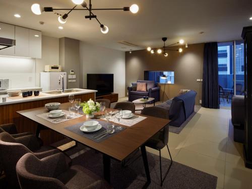 a kitchen and living room with a table and chairs at Minn Umeda North in Osaka