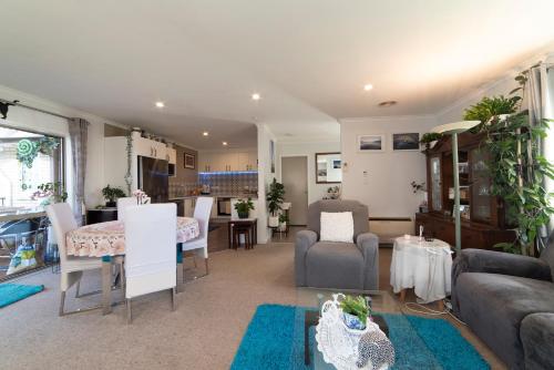 a living room with a couch and a table at Relaxing home from home in Invercargill