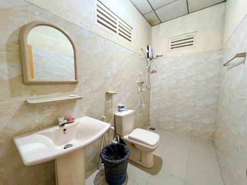 a bathroom with a sink and a toilet at Silent Bungalow in Udawalawe