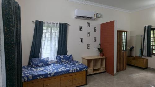 a bedroom with a bed and a window at REJOICE Homestay in Kalyānpur