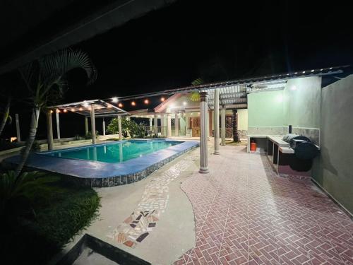 a swimming pool in a backyard at night at Casa de Campo Loma Linda in Puerto Cortes