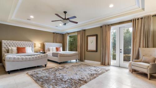 a bedroom with two beds and a ceiling fan at Hilltop Estate w Pool Hot Tub Fire Pit Views Cleveland Vista by AvantStay in Murrieta