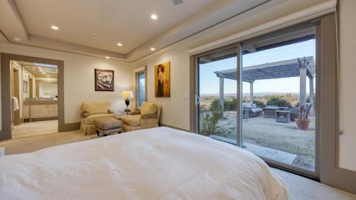 a bedroom with a large bed and a large window at Private Pool Firepit Wine Room Near Top Paso Wineries Devi Ranch in Paso Robles