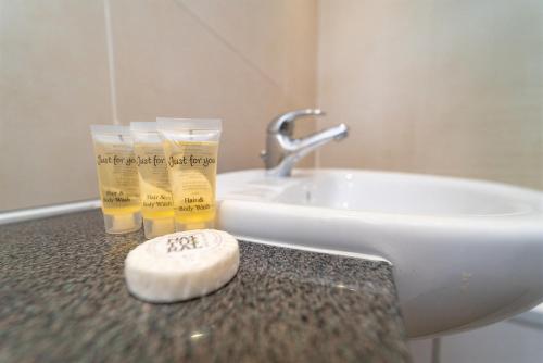 a bathroom counter with two glasses and a sink at Family Friendly 3BR Townhouse with 6 Beds and Parking in Edinburgh