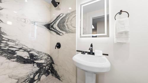 a bathroom with a sink and a toilet and a mirror at Cozy Forest Hideaway in Incline Village Private Balcony Sierra Solace by AvantStay in Incline Village